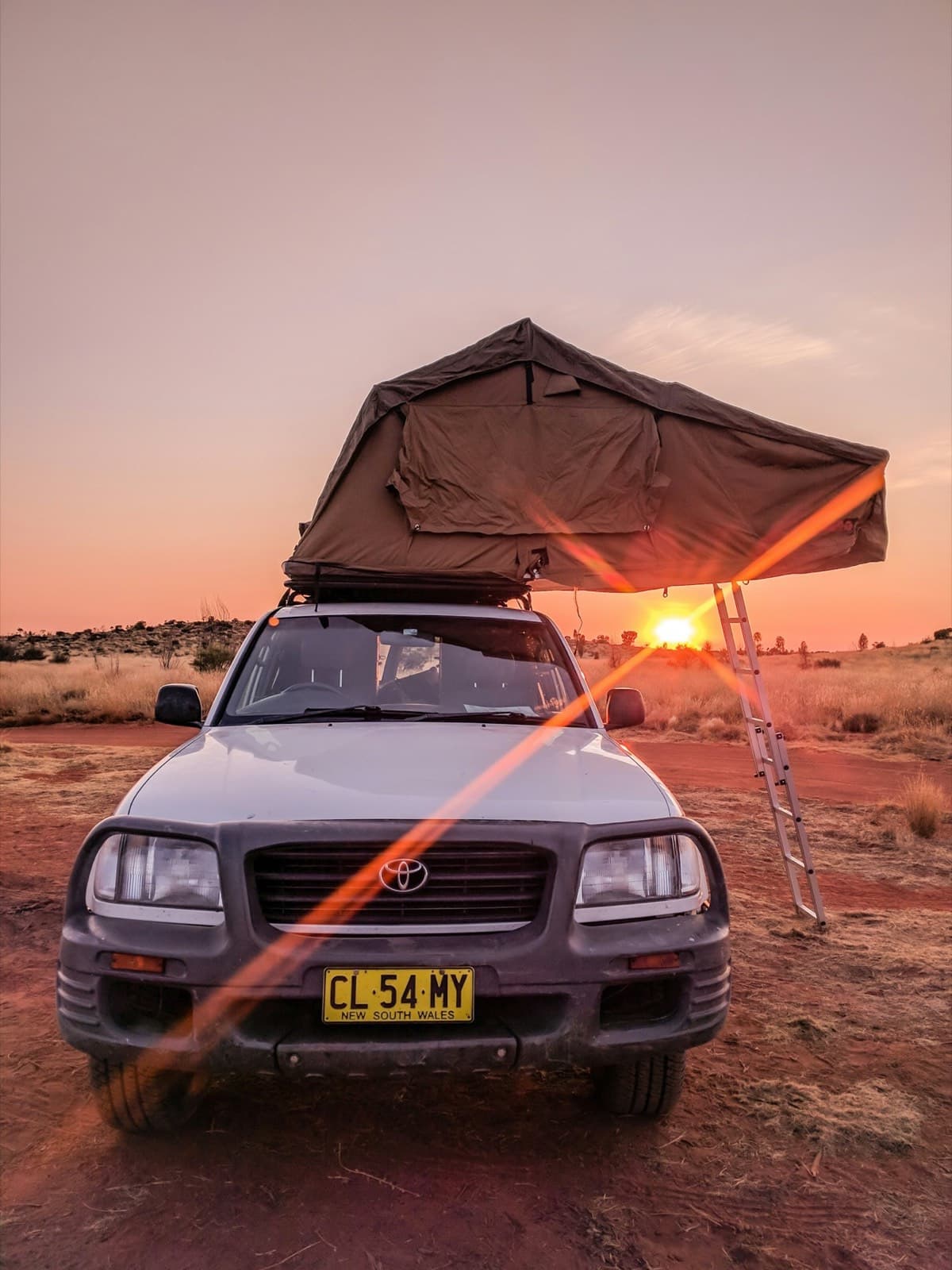 Land Cruiser with a rooftop tent at sunset